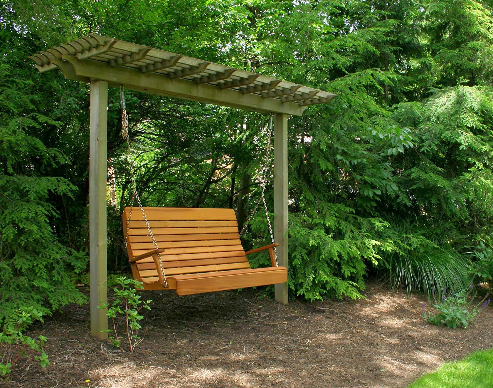 A wooden swing inside a bushy garden