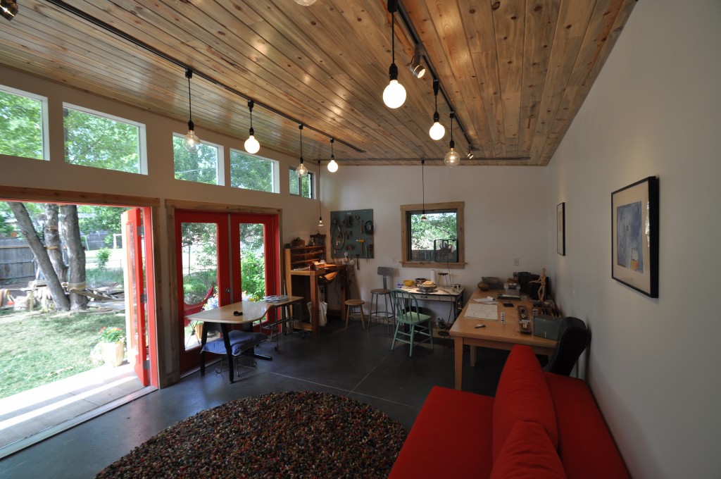 Art-studio-with-a-gentle-shade-of-wood-and-vibrant-red-elements-