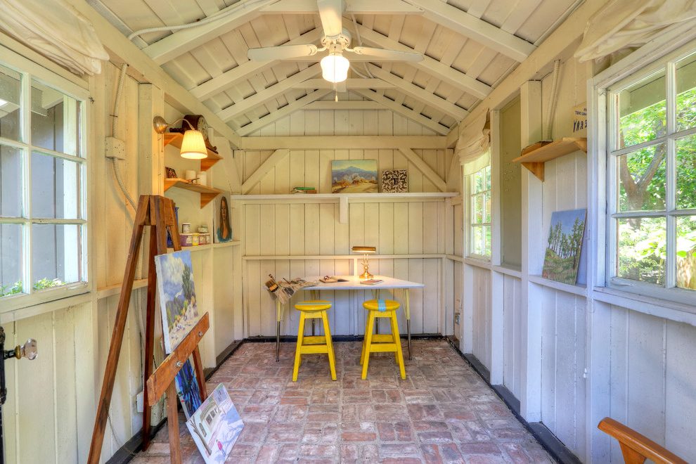 Yellow stools in an art studio with brick flooring.