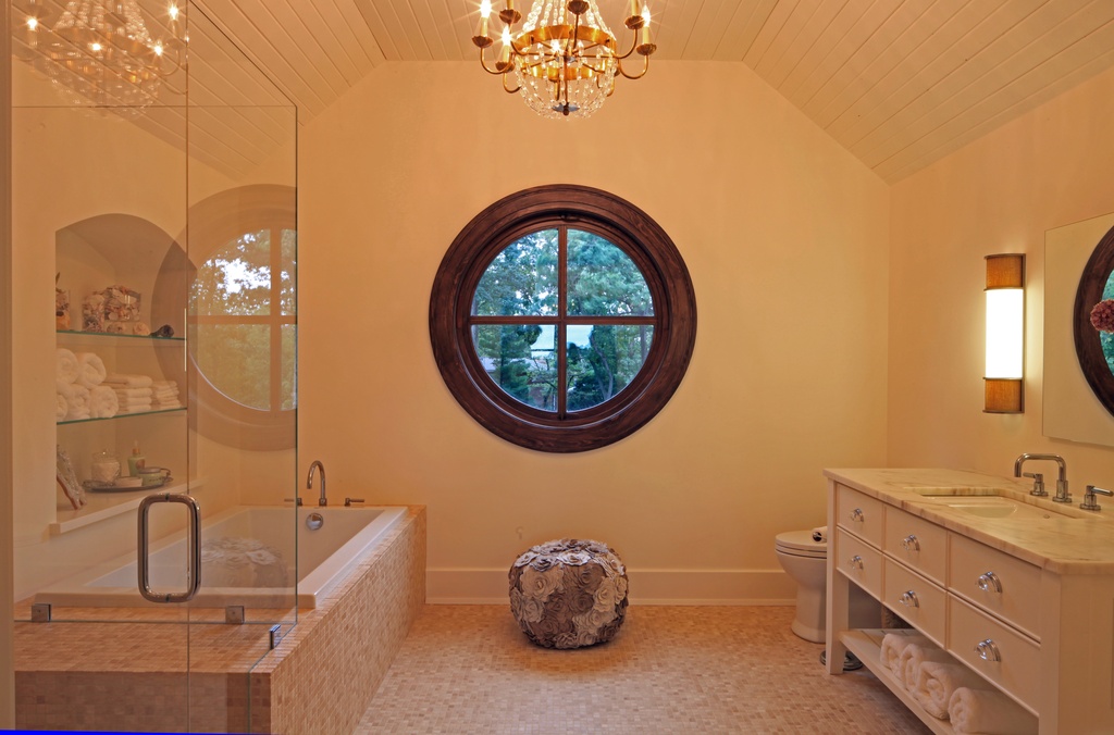 Bathroom-with-a-round-window-that-contrasts-the-interior