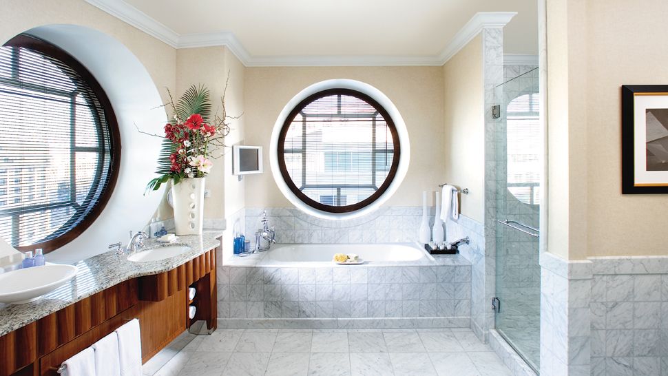 Bathroom with soft beige walls and big round windows