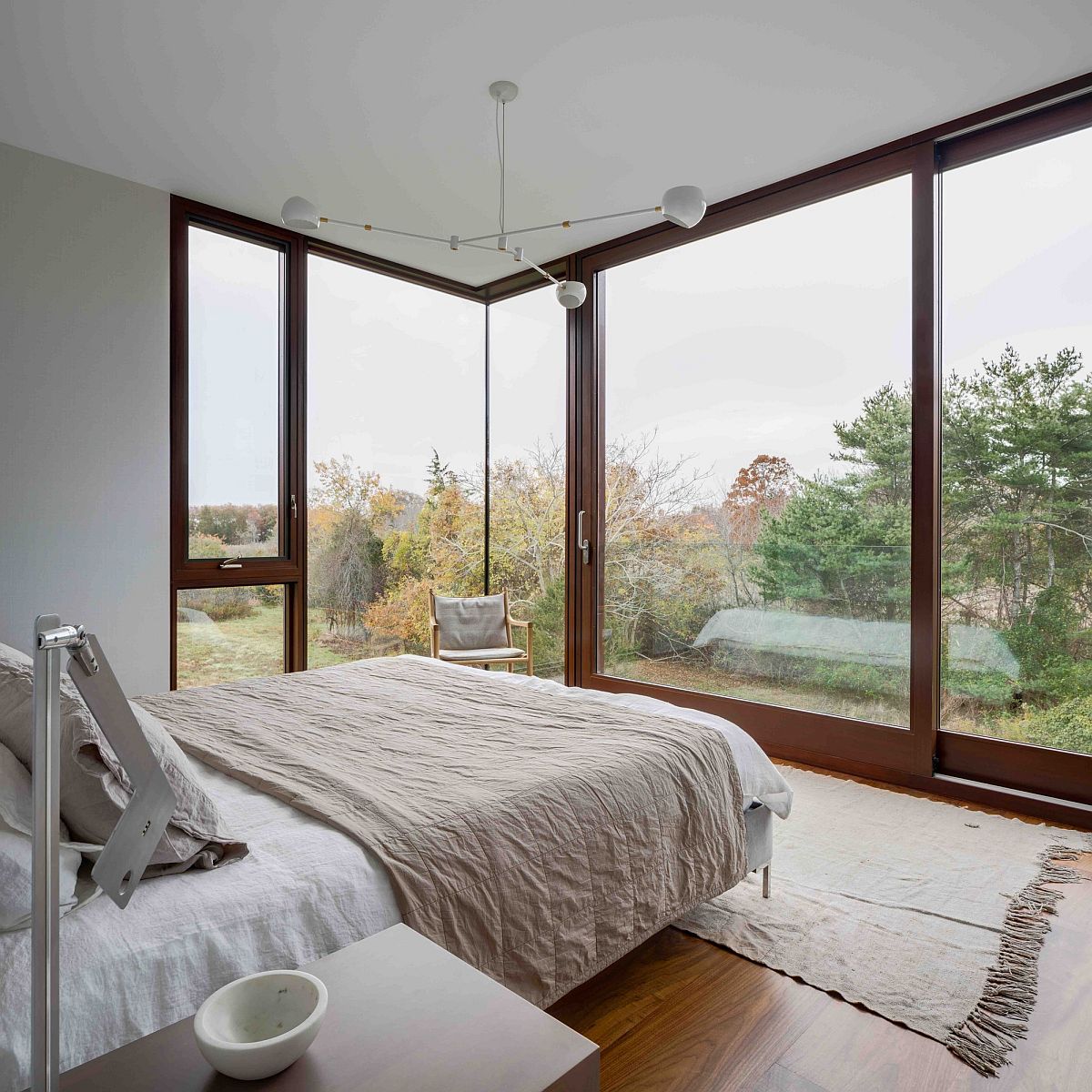 Bedroom in white with large sliding glass doors