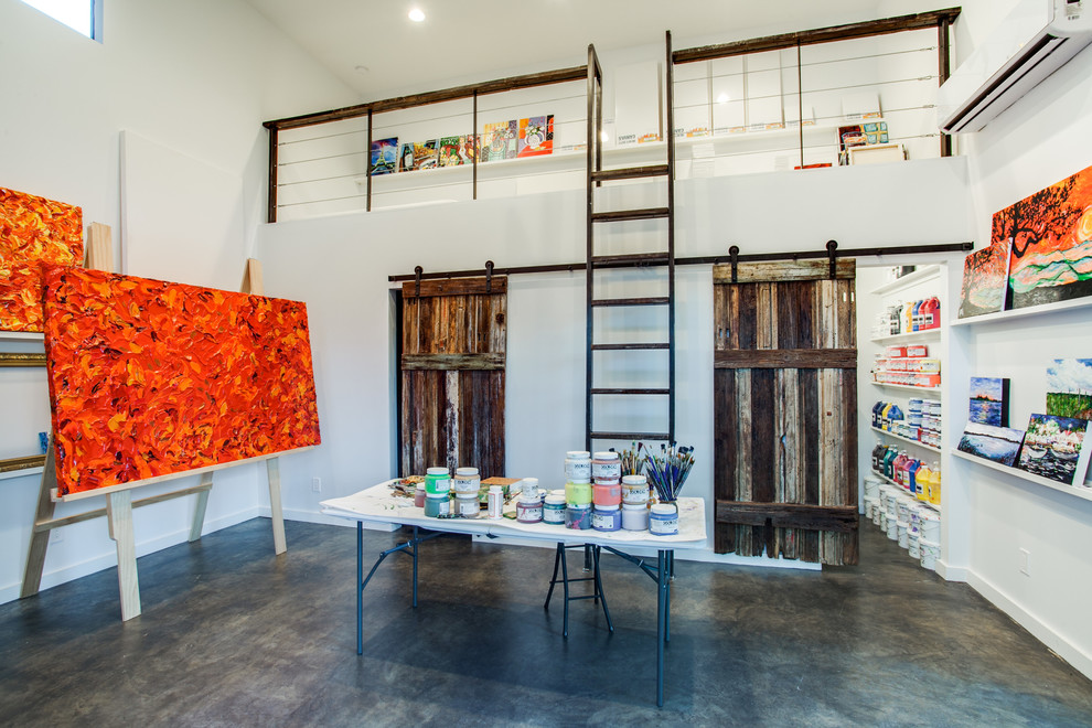 home art studio with rustic sliding doors and white shelves