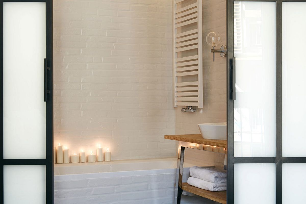 Candles add warmth and elegance to the bathroom in white