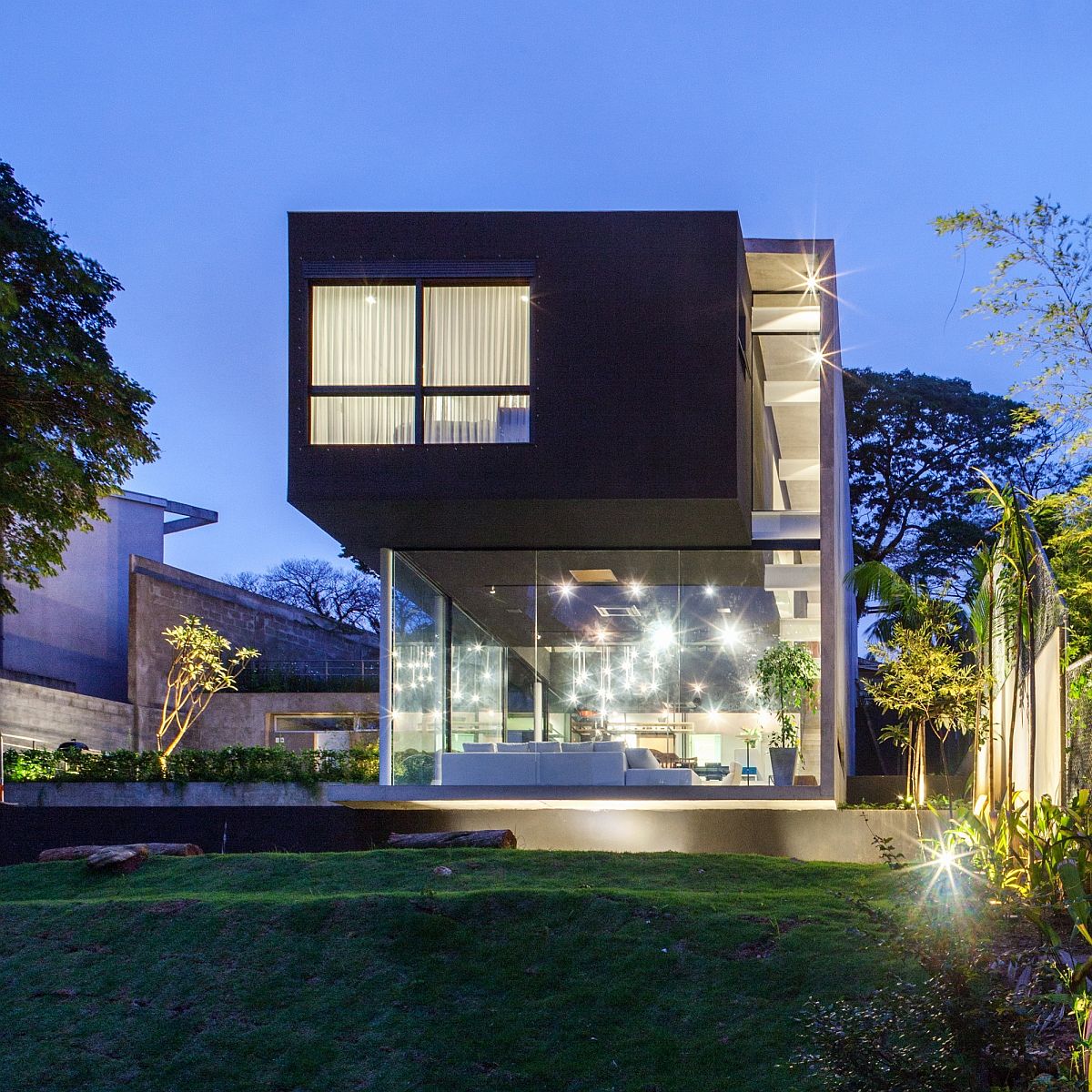 Cantilevered top structure sits lightly above the glazed lower level