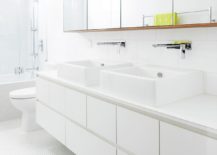 Contemporary-all-white-bathroom-with-penny-tile-flooring-217x155