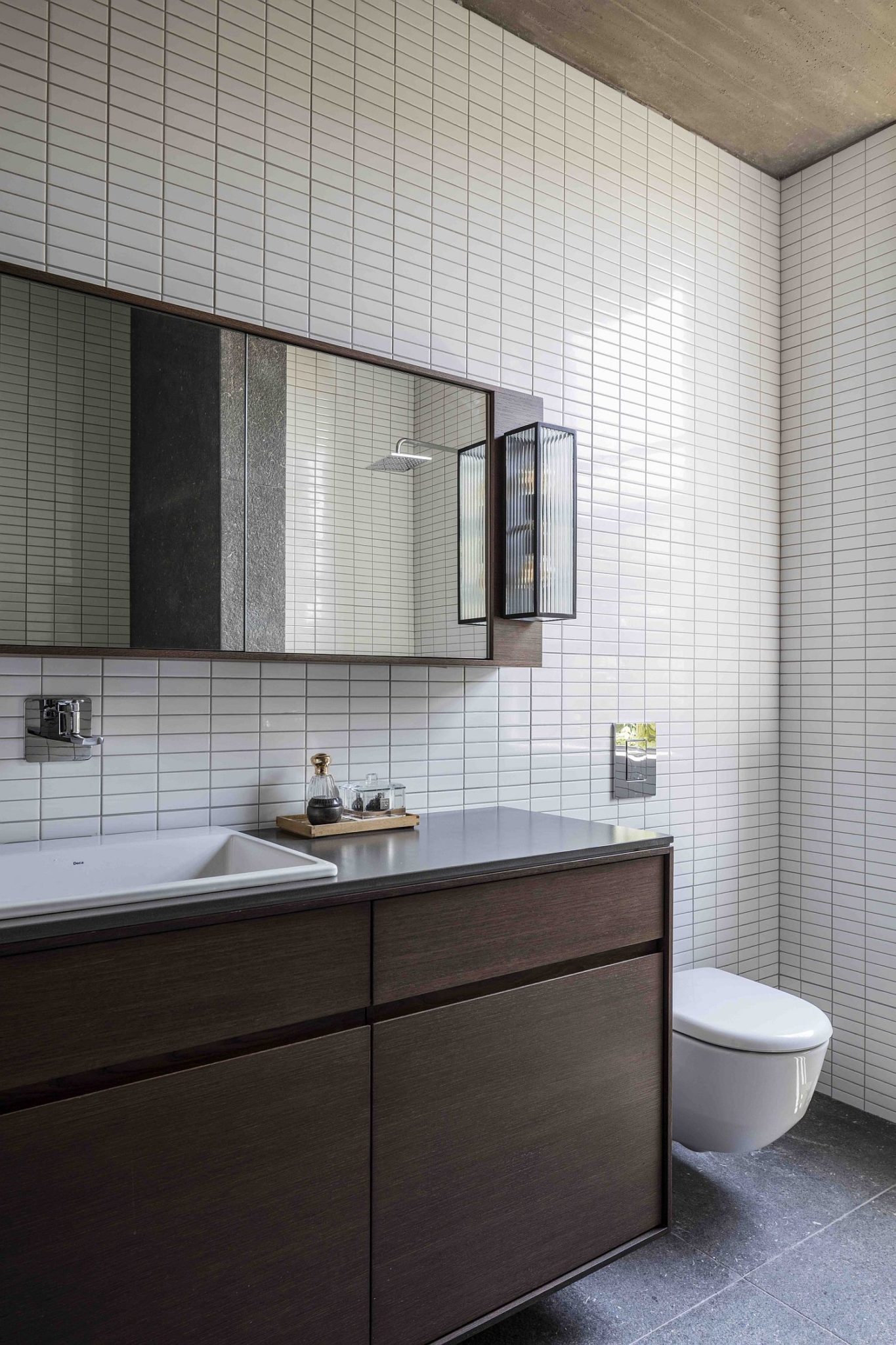 Contemporary bathroom with white tiles and a wooden vanity