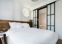 Contemporary-bedroom-in-white-allows-the-wooden-headboard-to-stand-out-visually-217x155