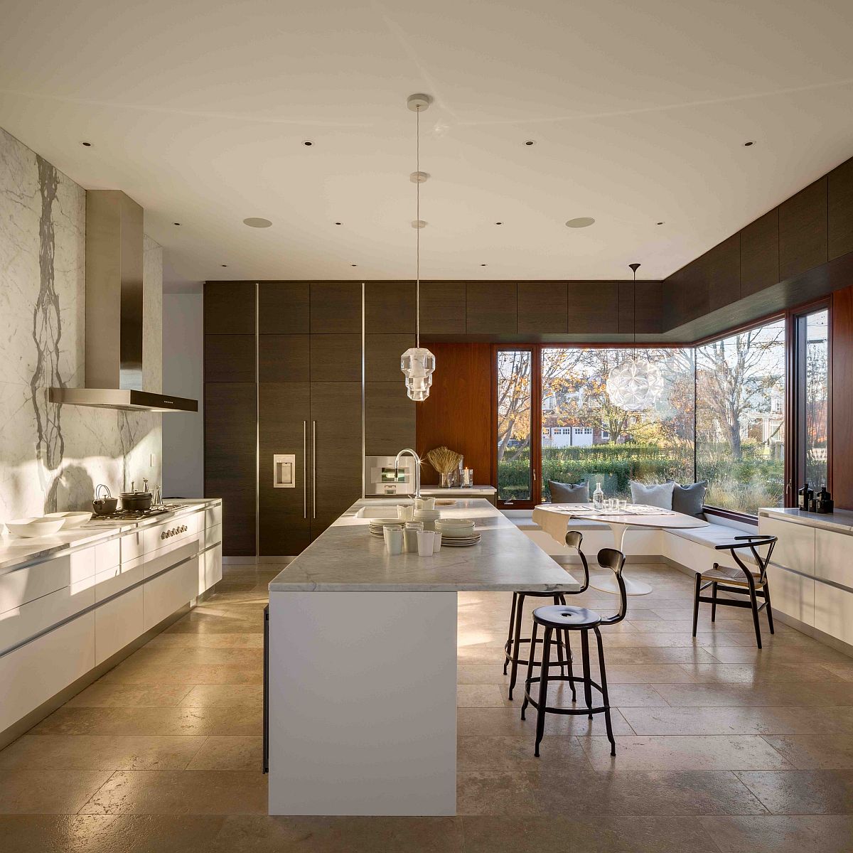 Corner window in the kitchen with seating gives a glimpse of the outdoors