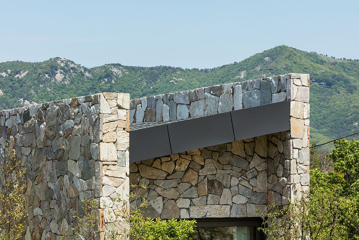 Differently layered stone walls make up the structure of the home