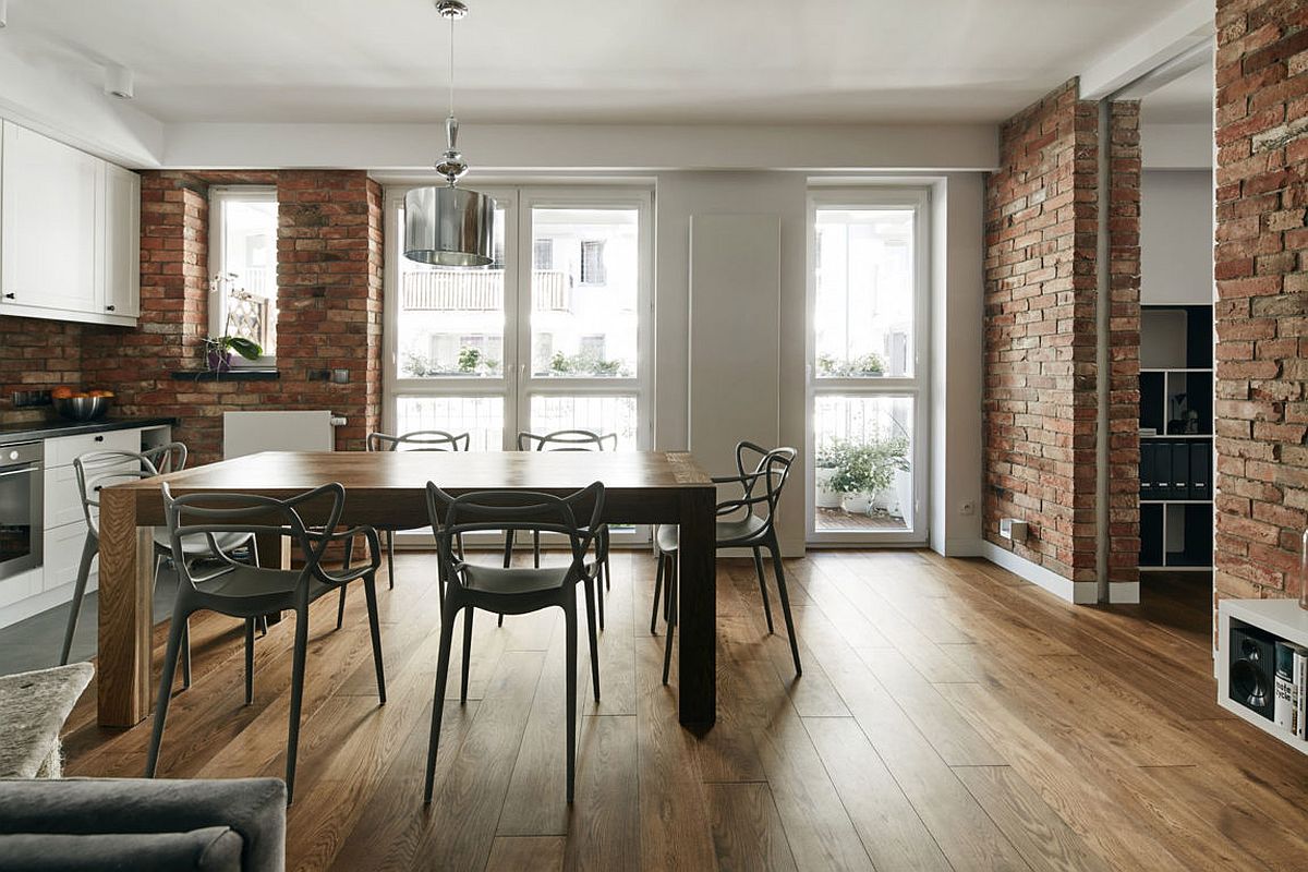 Dining room with sculptural chairs and exposed brick walls