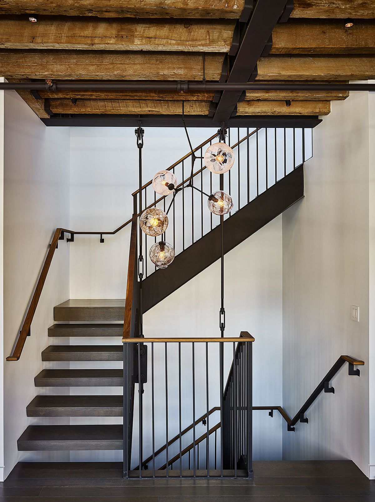 Exposed wooden beams and metallic elements inside the New York penthouse