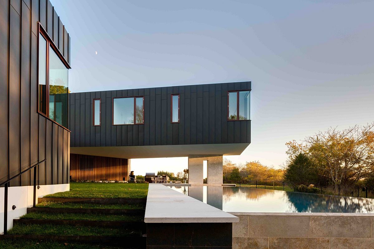 Gray exterior of the Long Island home overlooking the pool