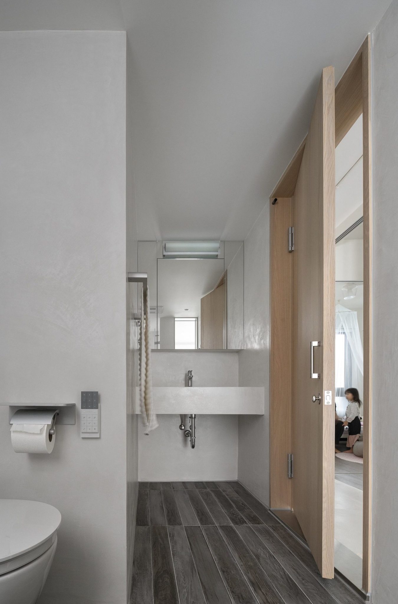 Gray wooden flooring for modern bathroom in white