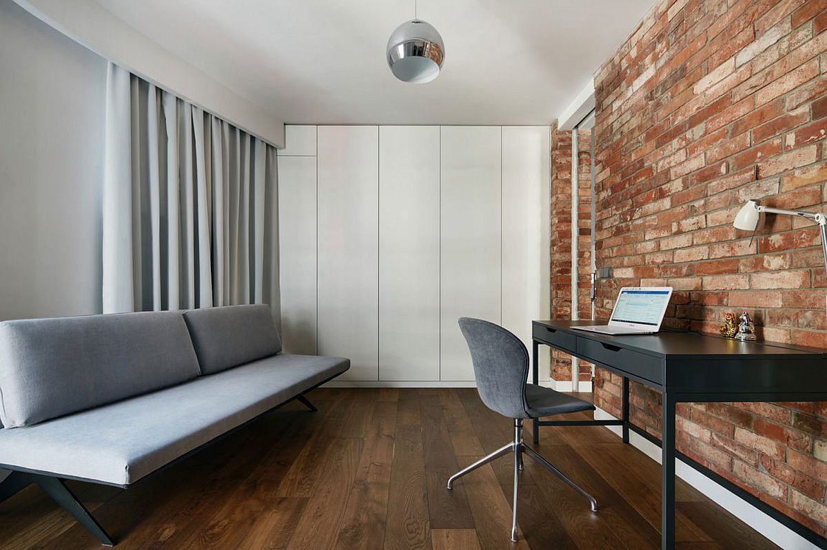 Home office in white and gray with exposed brick wall