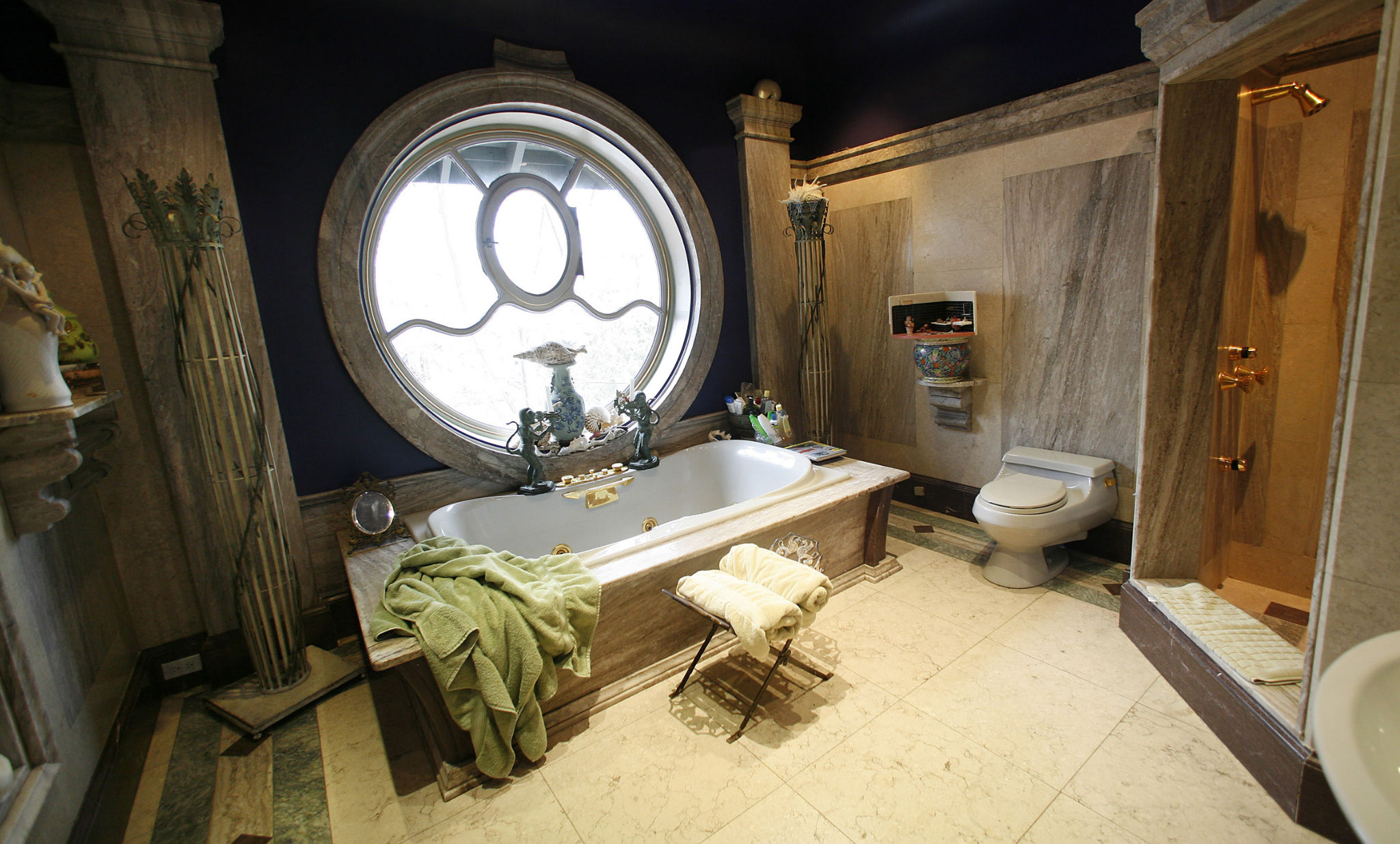 Huge round window in an antique bathroom