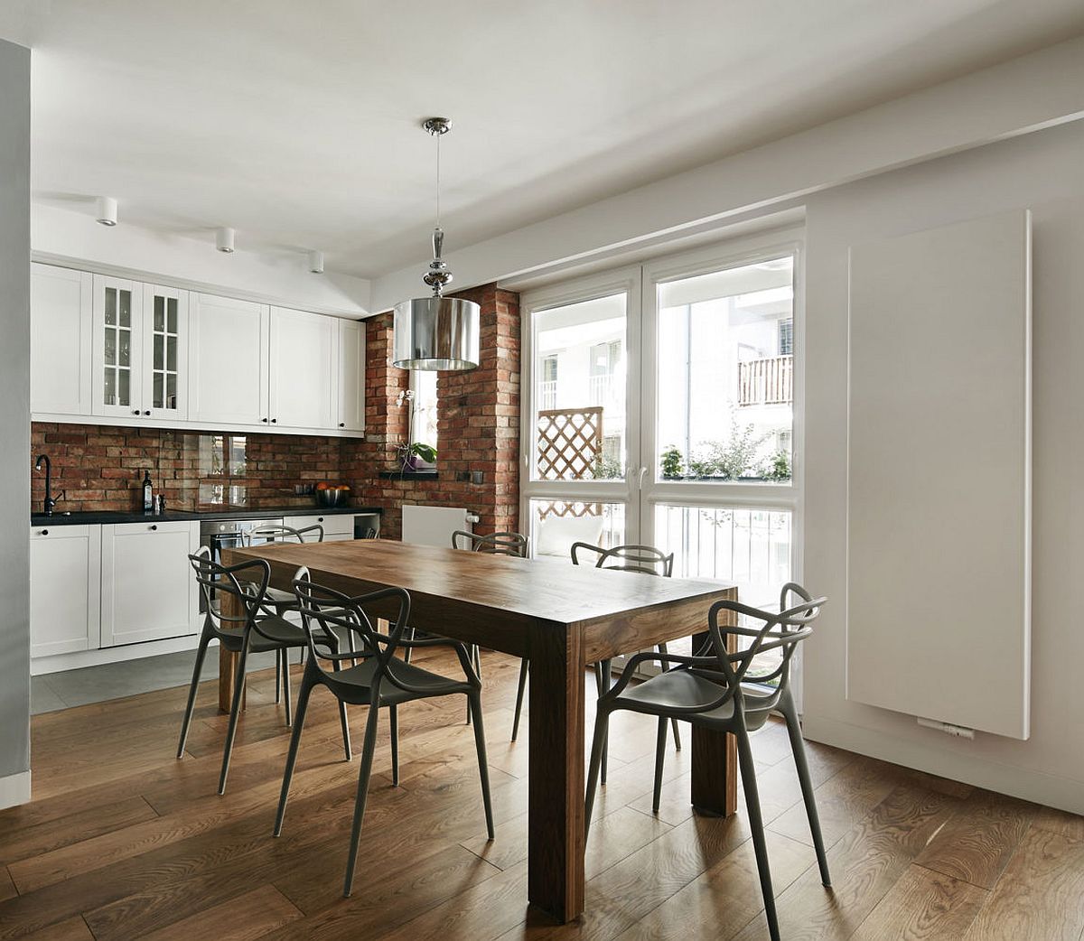 Kitchen and dining area rolled into one inside the small Krakow apartment