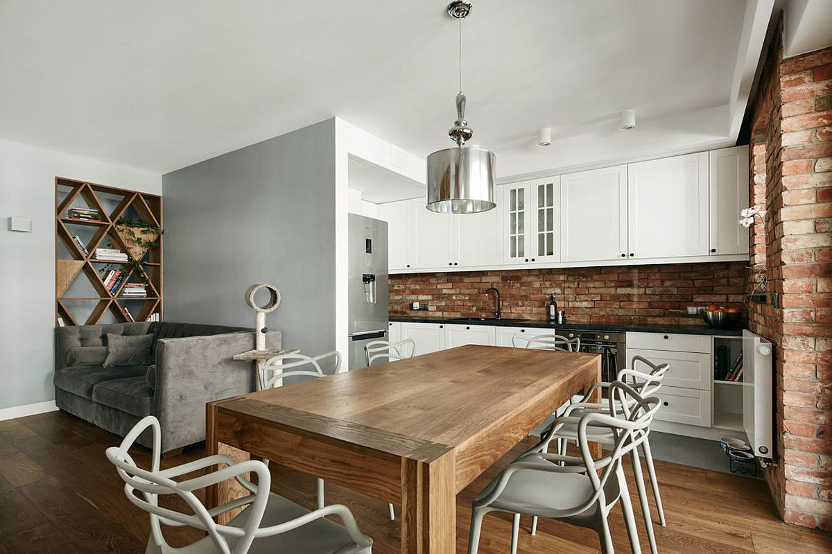 Kitchen with white cabinets and exposed brick walls