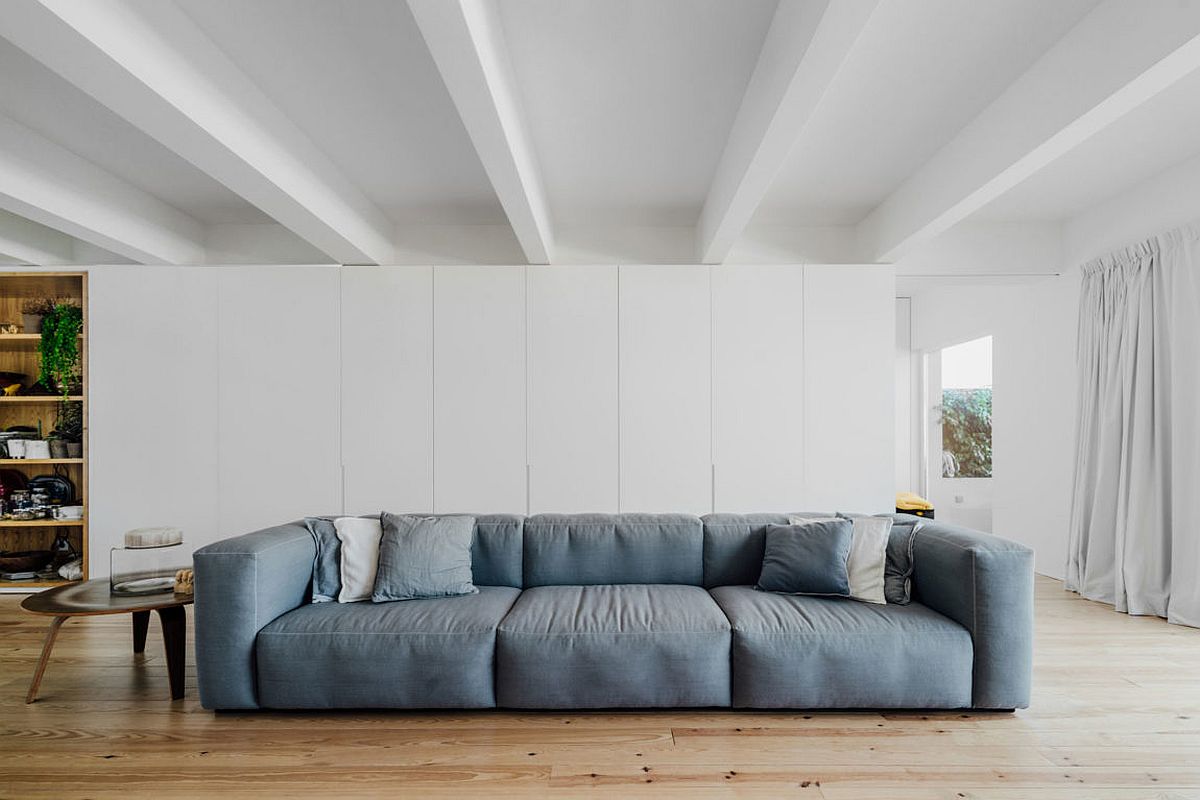 Light blue couche is a trendy choice for the urbane apartment living space