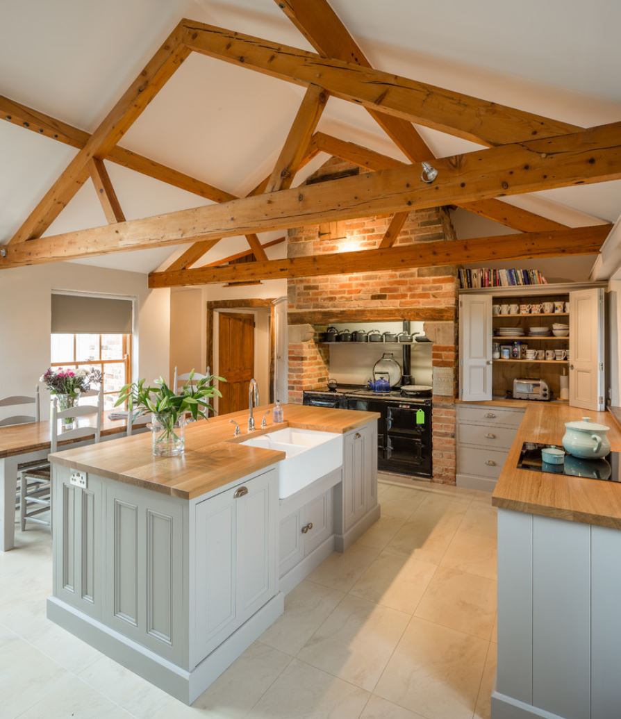 Light wooden countertop in a kitchen with visible beams