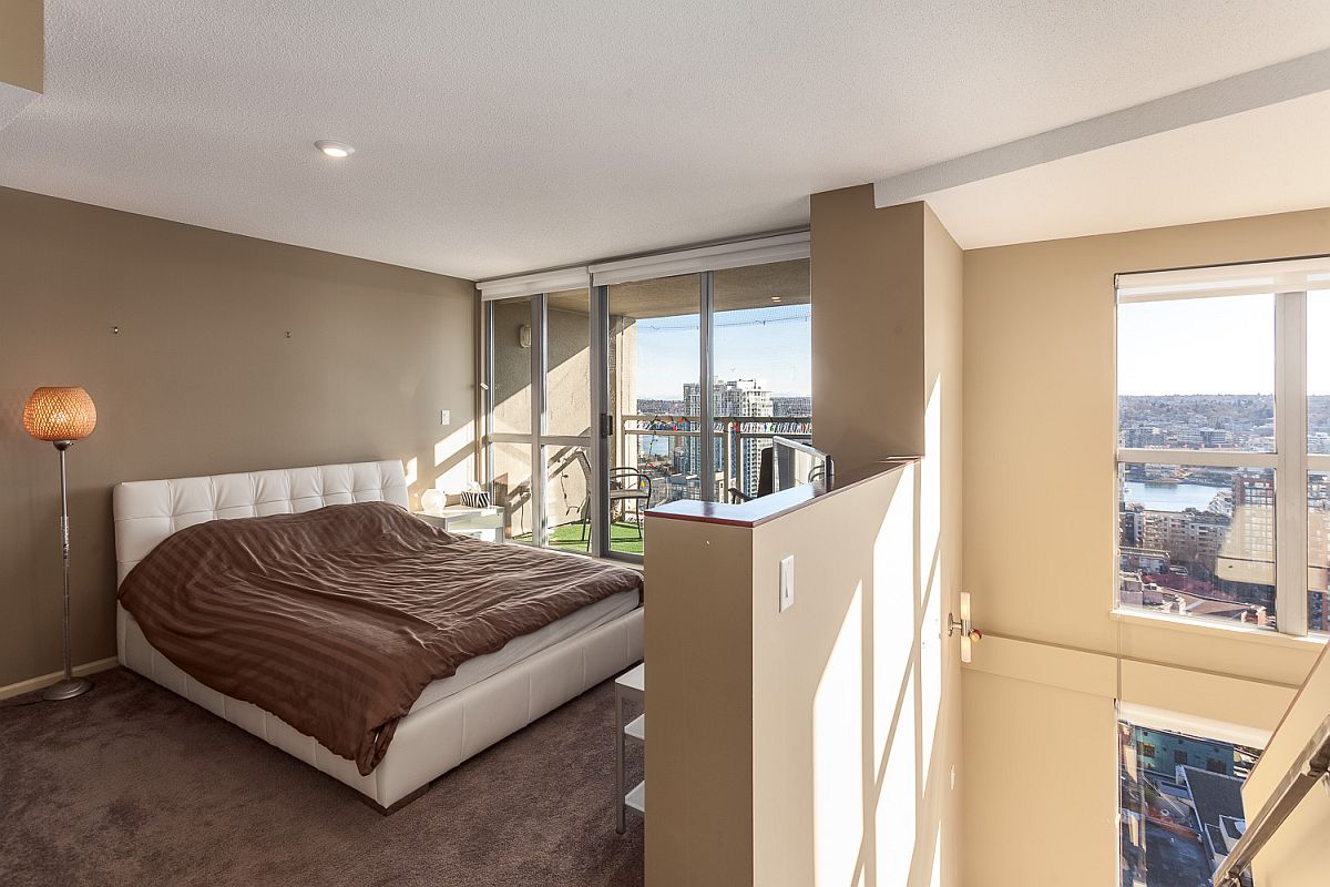 Loft level bedroom with a view of the living area below