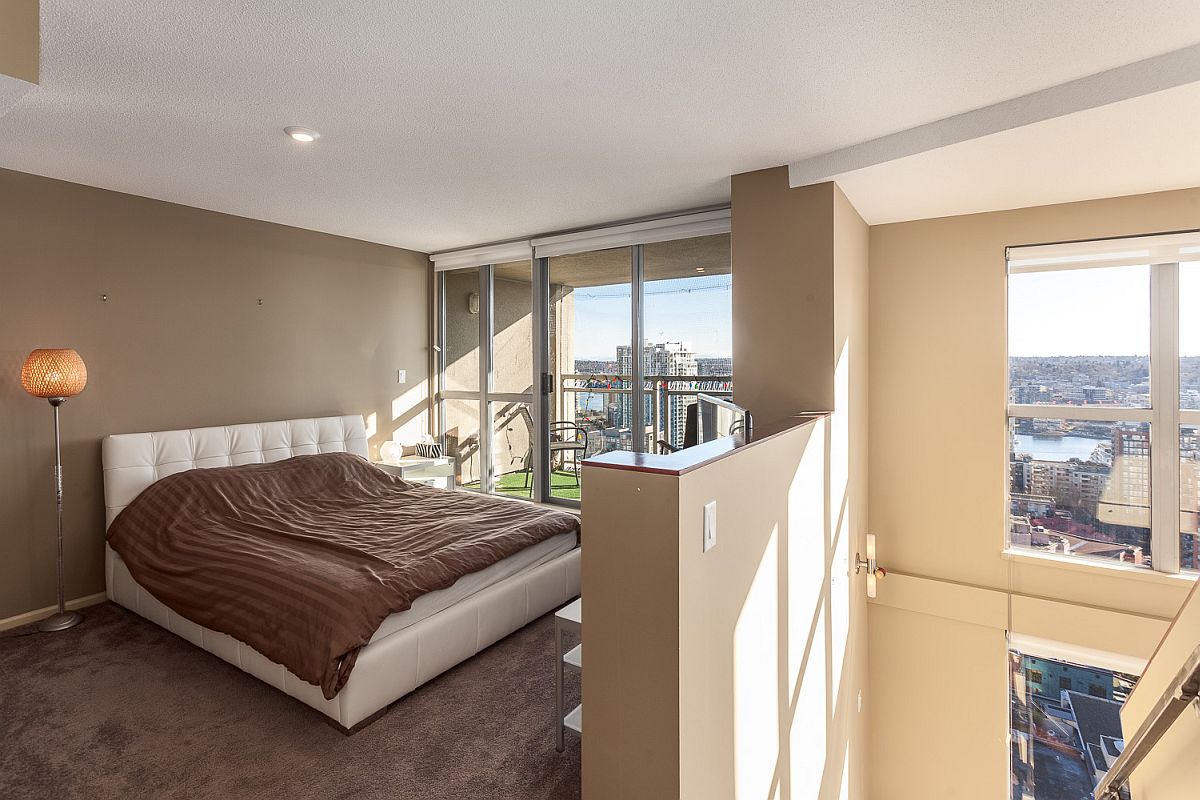 Loft-level-bedroom-with-a-view-of-the-living-area-below