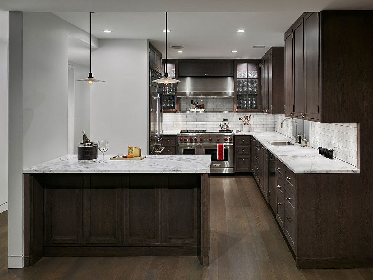 Marble countertops combined with dark wood shelves in the kitchen