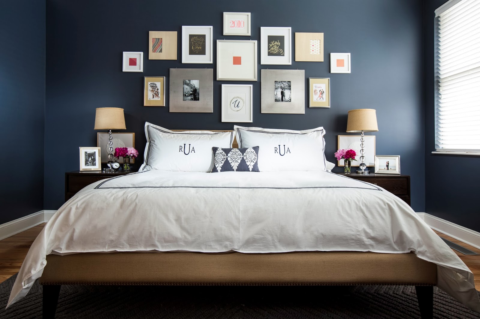 Misty blue bedroom with a wall gallery