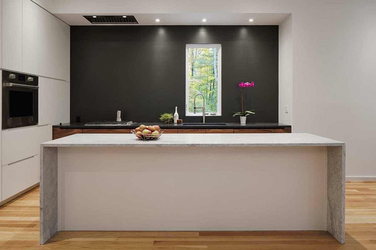 Modern kitchen in white with a dark accent wall