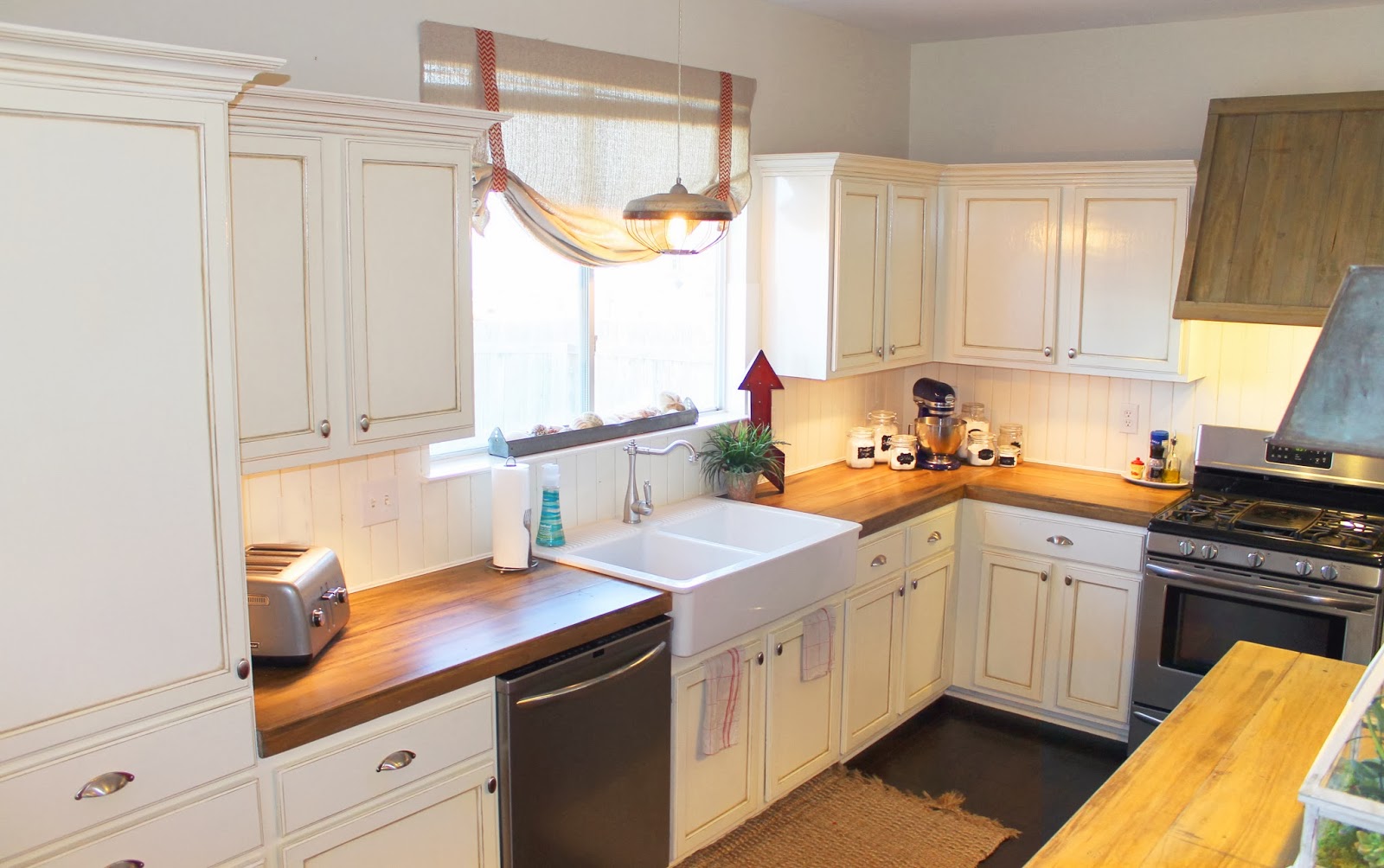 Narrow-white-kitchen-with-a-simplistic-wooden-countertop