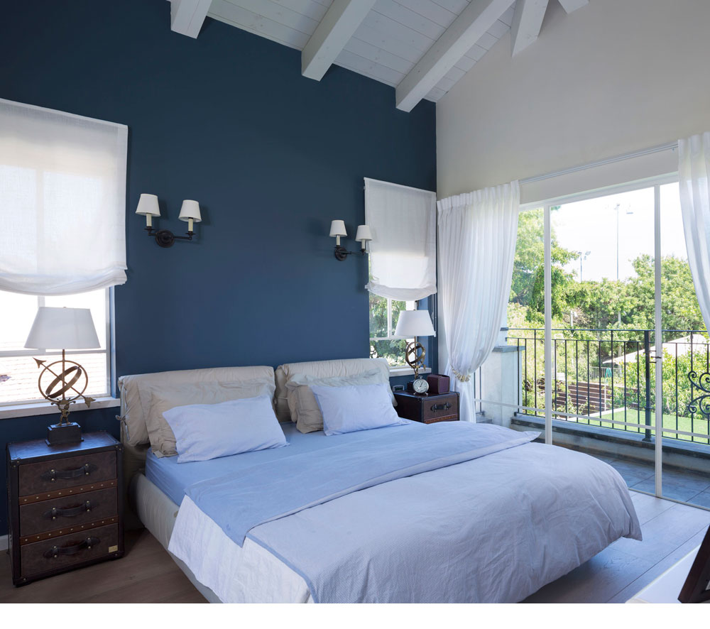 Open blue bedroom with a dark charisma