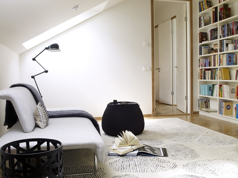 Peaceful modern reading nook with bare walls