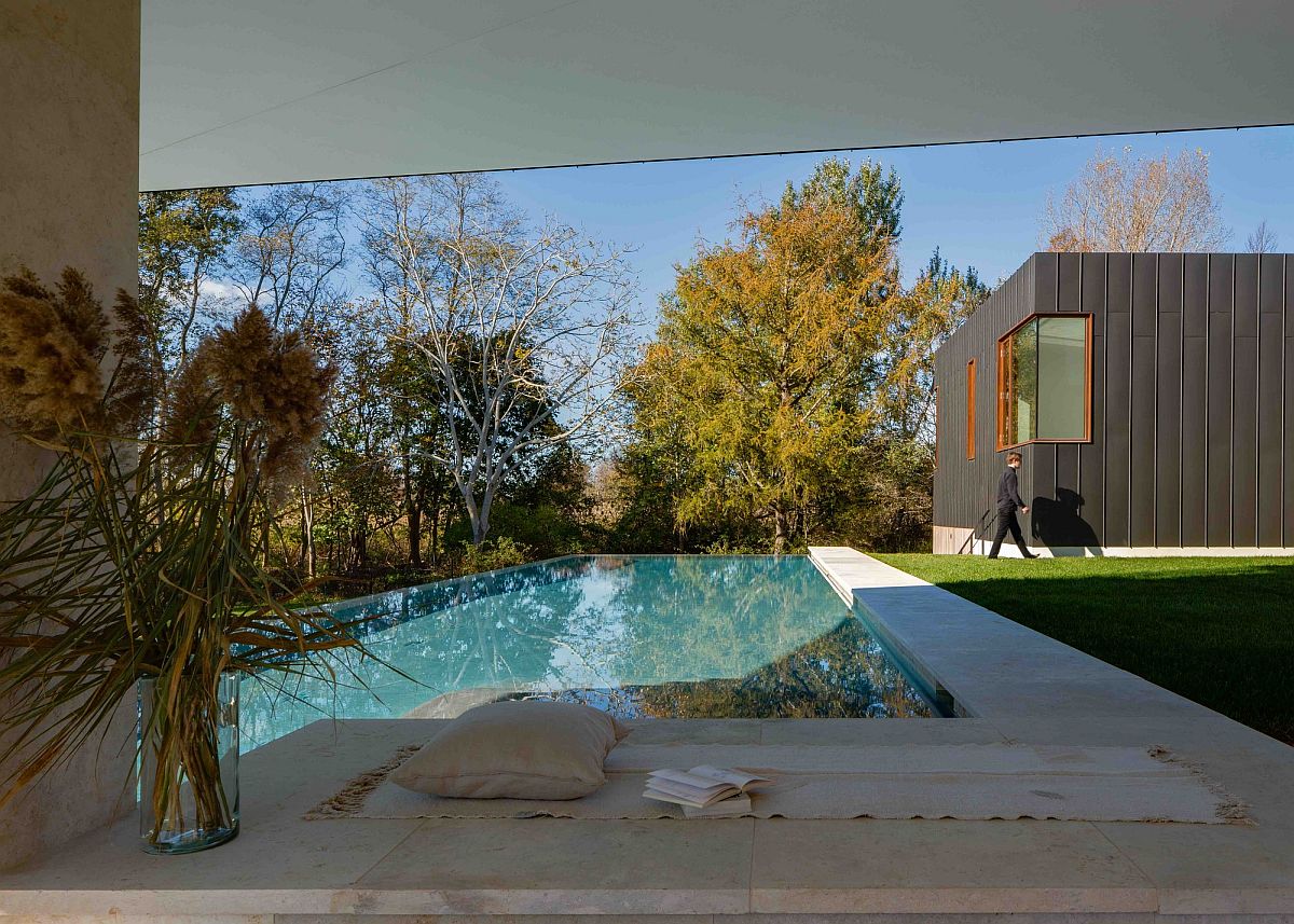 Pool deck and outdoor garden of the Long Island home