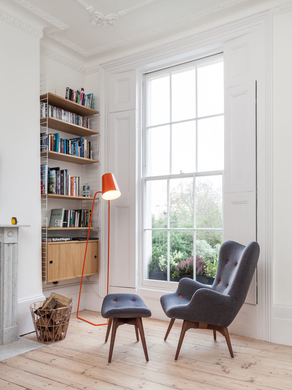 Reading nook with a dynamic reading chair and contemporary lamp