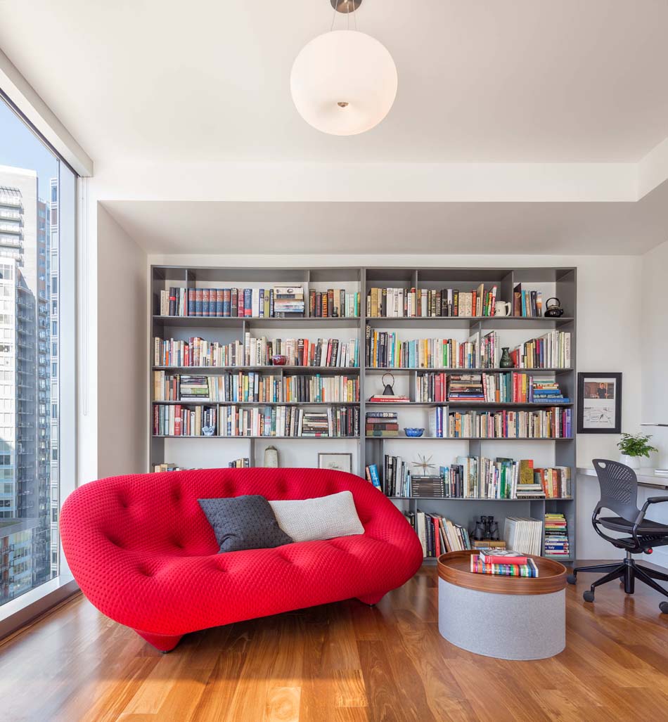 Reading nook with a lively sofa in a bold red color