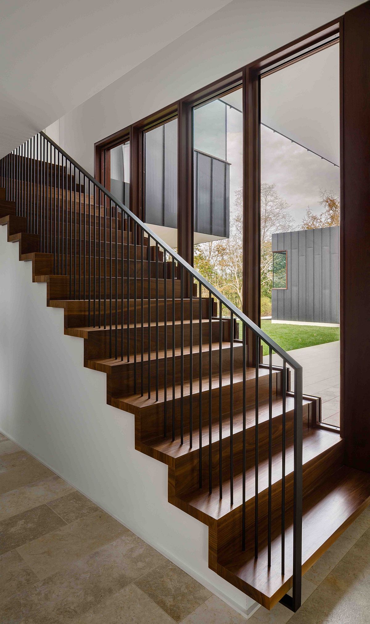 Simple wooden staircase with large glass doors