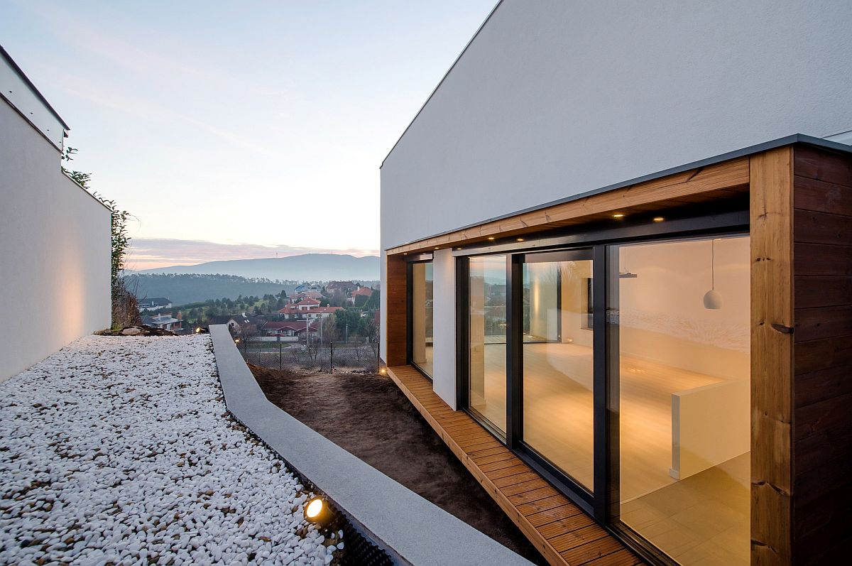 Sliding glass doors open towards the landscape with stunning views