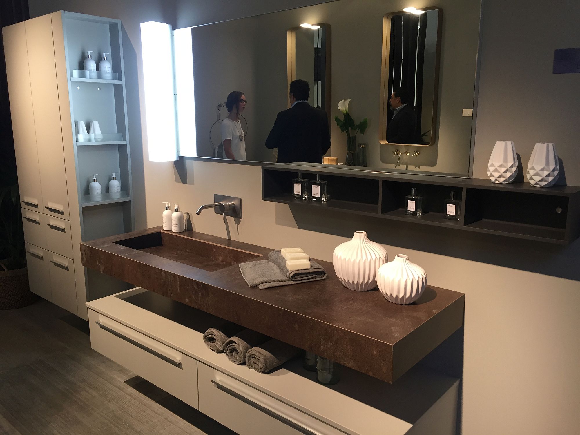 Space between the floating vanity and the cabinet below is the perfect spot to stack those towels