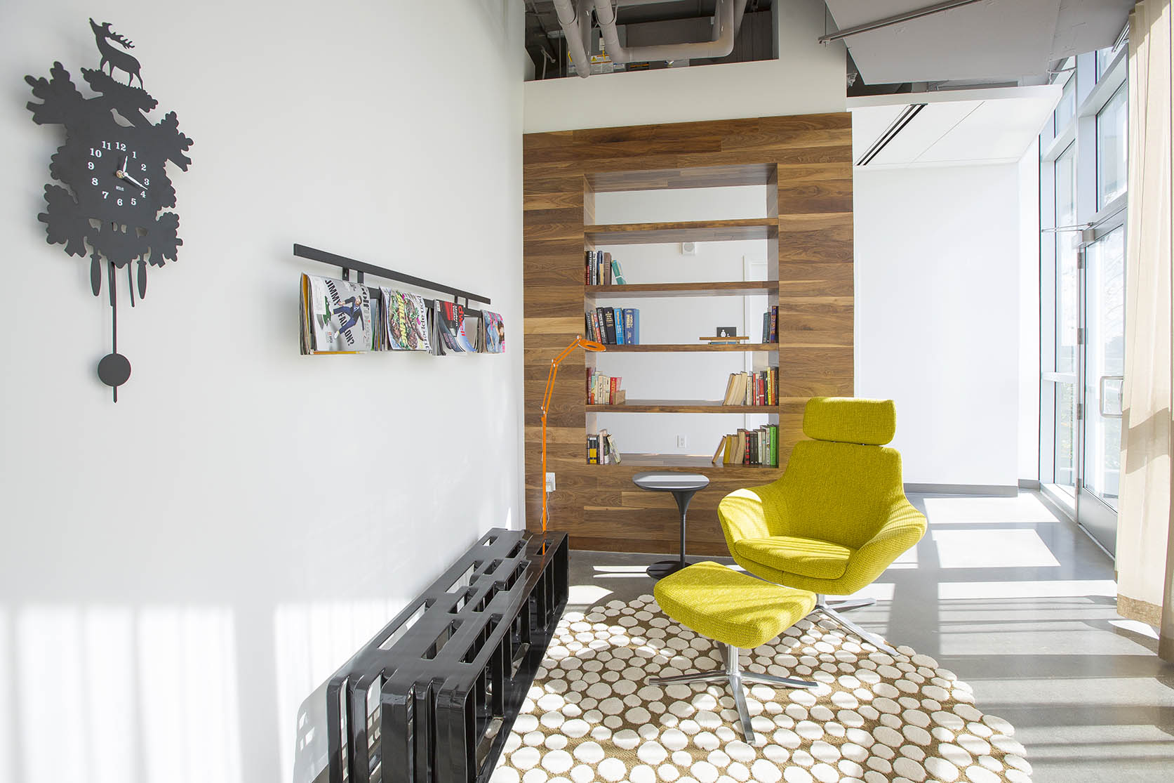 Spacious and open reading nook with a modern yellow chair