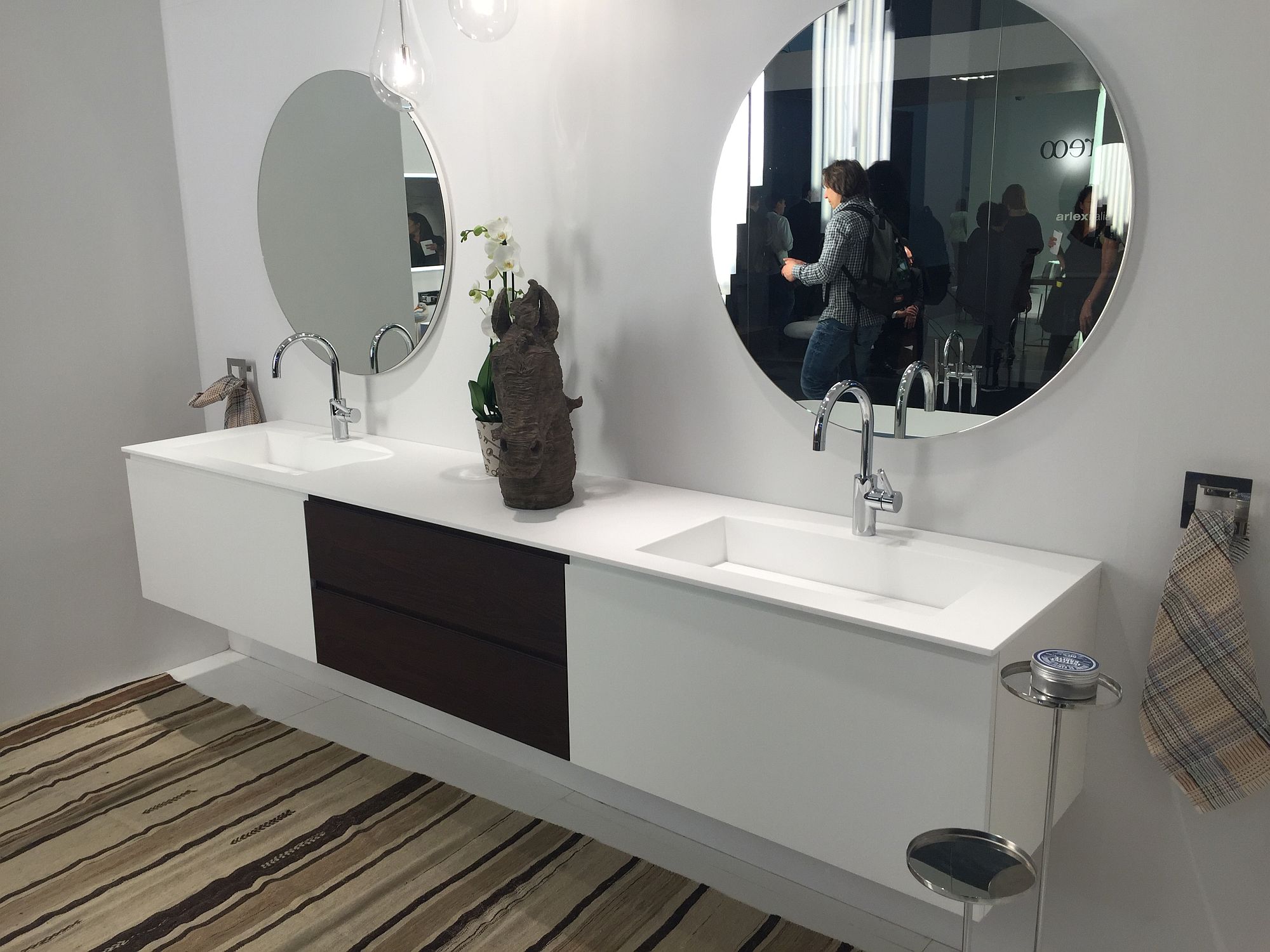 Stylish use of towel hooks on each side of the vanity brings symmetry to the setting