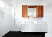 Wooden-cabinet-and-dark-floor-bring-contrast-to-the-bathroom-217x155