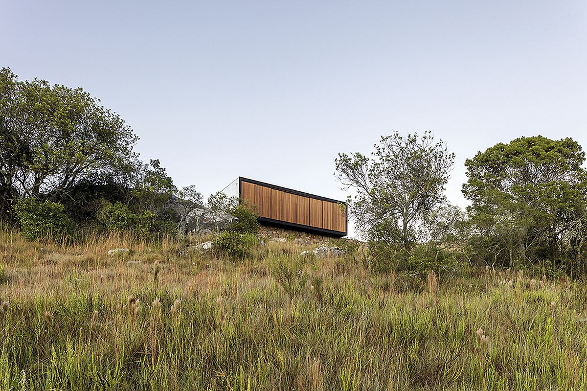 Wooden facade of the prefab can switch between unabated views and complete privacy