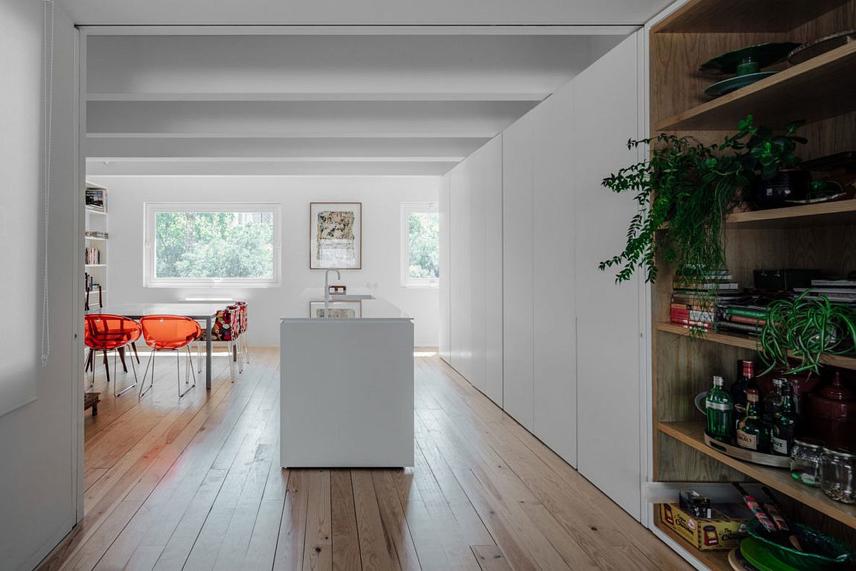 Wooden floor brings warmth to the polished interior in white