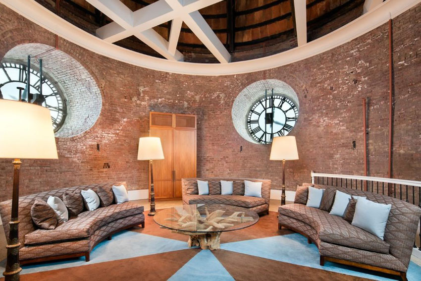 clock tower living room with two round windows