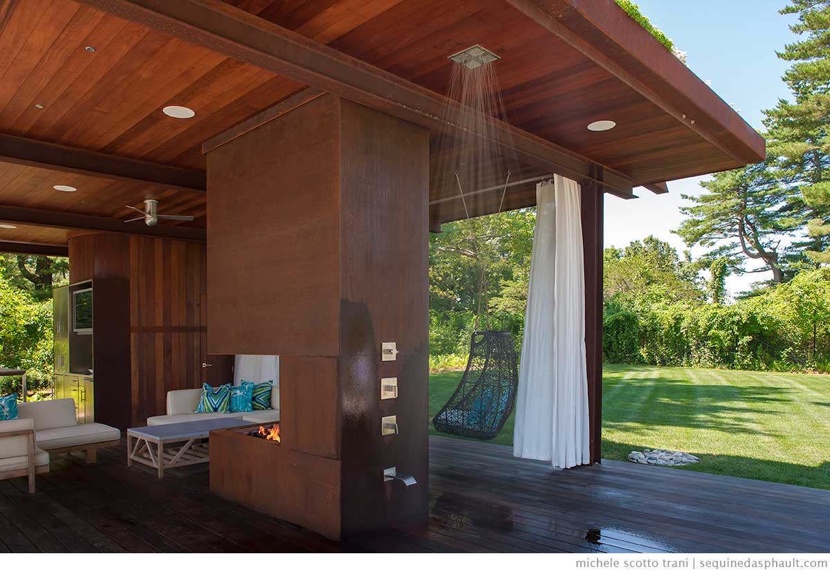 A subtle outdoor shower that hides itself in the sleek wooden decor