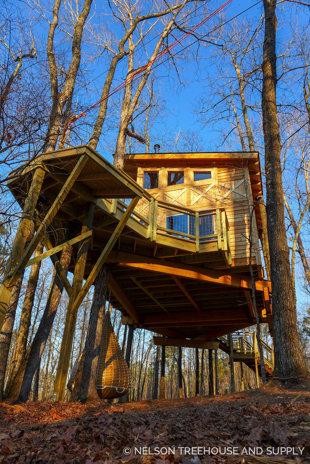 A wooden treehouse that blends in with the trees