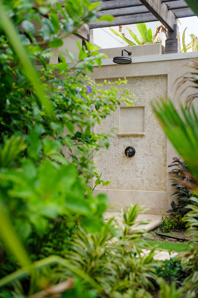 An almost hidden outdoor shower that grants privacy and comfort