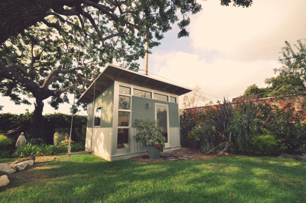 Backyard shed in a delicate shade of darkened green