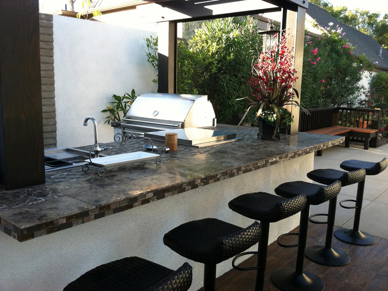 Bar-inspired outdoor kitchen with cute bar stools