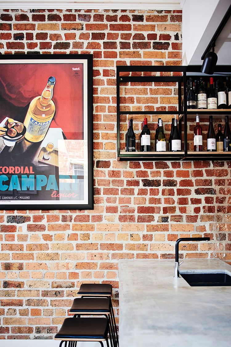 Brick wall and open metallic shelf give the kitchen an industrial vibe